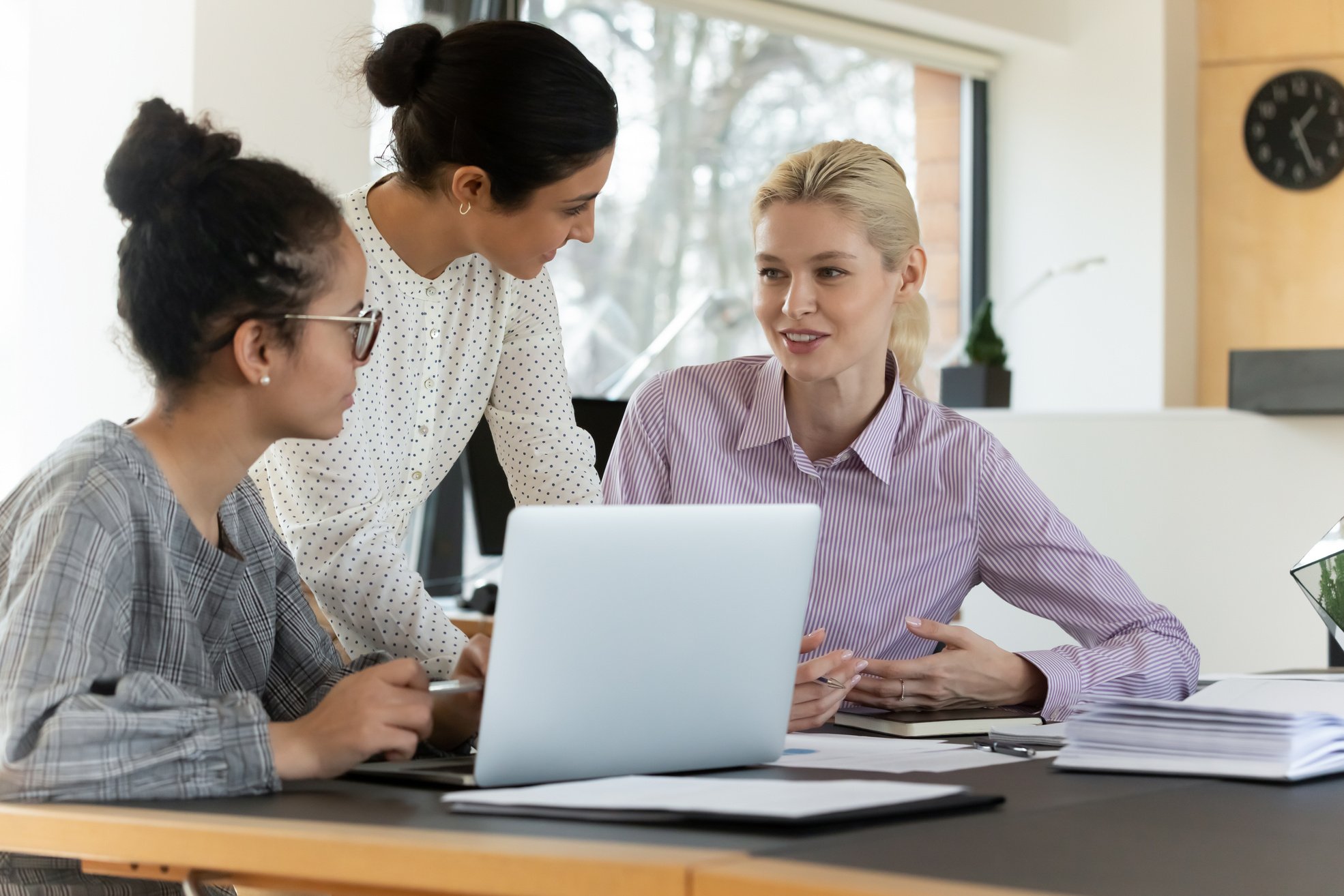 Multiracial Female Employees Discussing Project at the Office