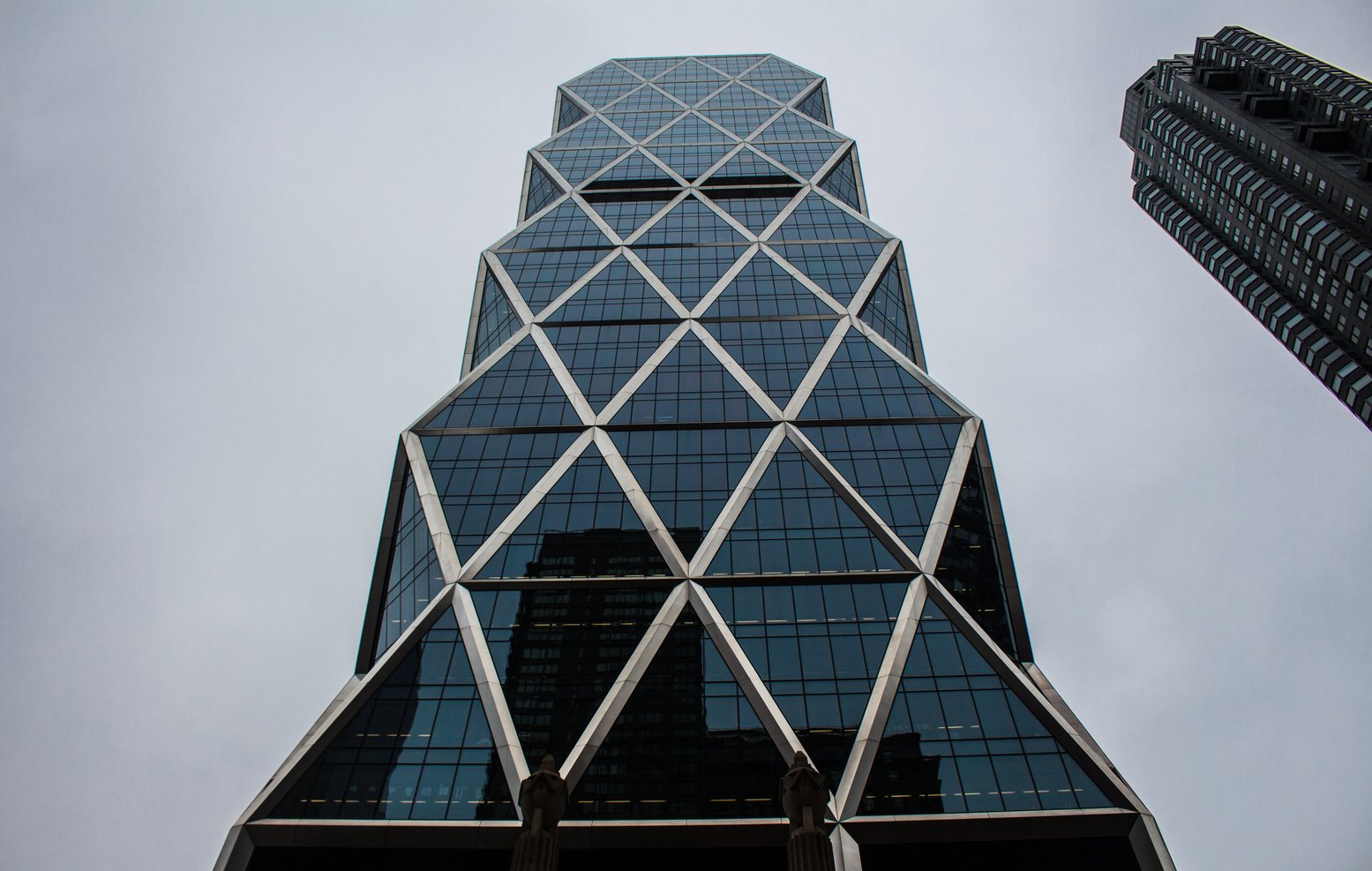 Low-angle Photography of Glass High Rise Building Under Gray Calm Sky